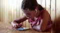 Girl with earpieces looks in his smartphone HD Footage