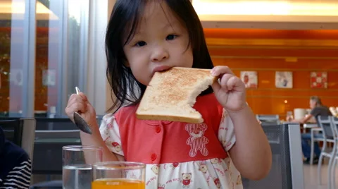 Girl eating bread for breakfast Stock Footage 63591232