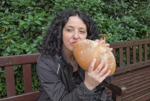 Girl eating bread Stock Photos