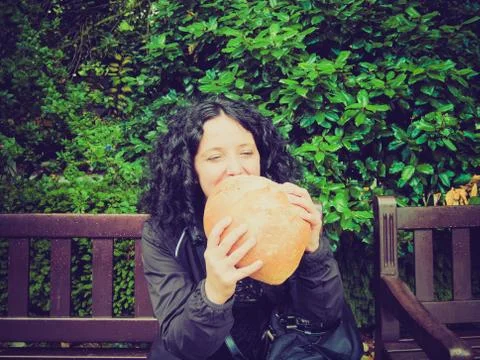 Girl eating bread Stock Photos