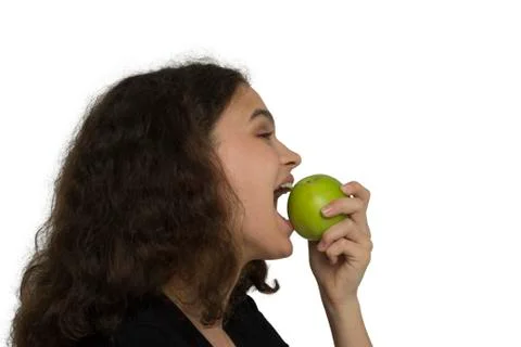 Girl eating green apple isolated Stock Photos