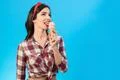 The girl eating an ice cream on the blue background Photo