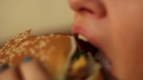 Girl eating a juicy Burger. Stock Footage
