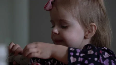 A girl eats and plays with bows Stock Footage 231900610