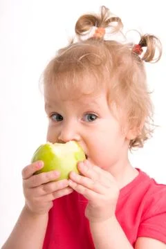 Girl eats an apple Stock Photos