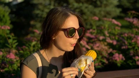 The girl eats boiled corn. Stock Footage 77171870