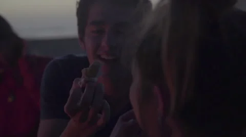 Girl eats from boys hand Stock Footage 53467912
