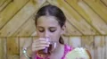 Girl eats bread and drinks tea HD Footage