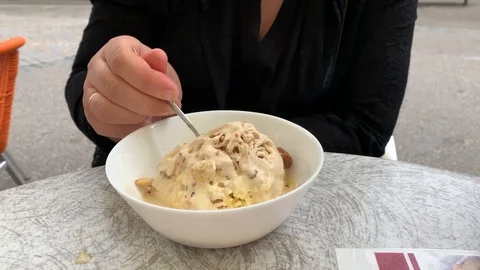 The girl eats in a cafe, peanut ice cream Stock Footage 108714890