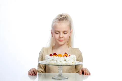 Girl eats a cake on white background. Stock Photos
