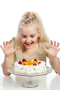 Girl eats a cake on white background. Stock Photos
