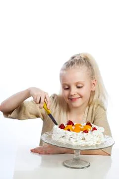 Girl eats a cake on white background. Fotos de archivo
