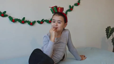 The girl eats a candy from the advent calendar. Stock Footage 253513352