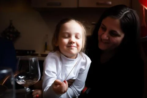 The girl eats cheese with blue mold in her mother Stock Photos