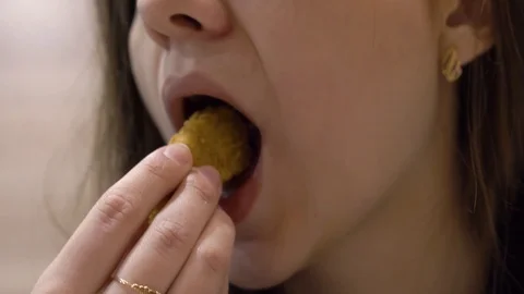 Girl eats chicken wing in batter Stock Footage 114753998