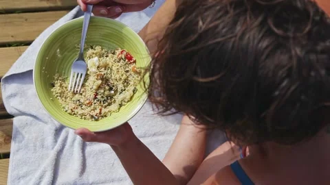 Girl eats couscous outdoors Stock-Footage 131313832