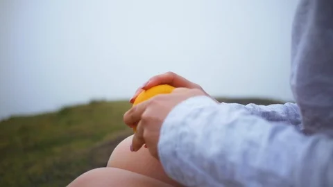 Girl eats fruit during a trip to the mountains Stock Footage 101563709