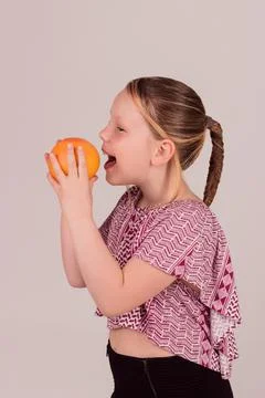 The girl eats grapefruit and laughs. Healthy eating, diet Stock Photos