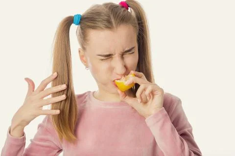 Girl eats lemon Photos