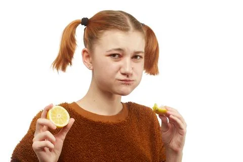 Girl eats lemon Фото