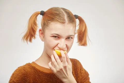 Girl eats lemon Foto stock