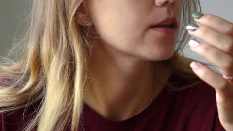 Girl eats meat with her hands licks her fingers Video stock 150955432