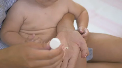 Girl eats pills with vitamins with mother's hands. Stock Footage