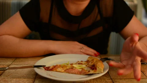 A girl eats pizza in a restaurant Stock Footage 91591910