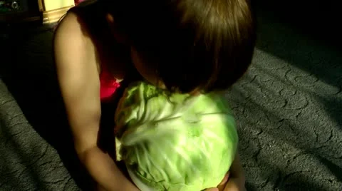The girl eats, plays about and plays with a head of cabbage Stock-Footage 11974110