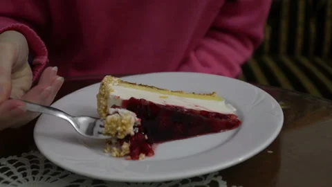 Girl Eats Raspberry Cheesecake In Cafe Stock Footage 123902894