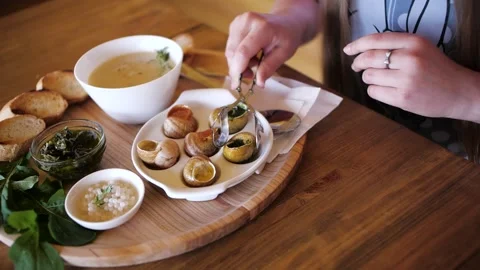 The girl eats snails. Delicacy Stock Footage 132622311