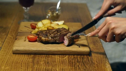 The girl eats a steak Stock Footage 88978686