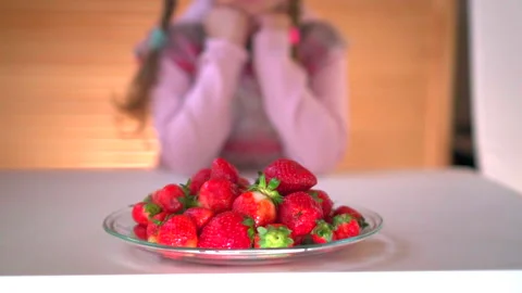 Girl eats strawberry Video stock 131556795