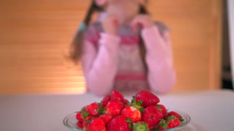 Girl eats strawberry Stock Footage 131556983
