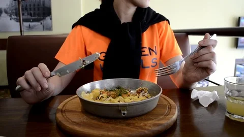 Girl eats at the table in Cafe Stock Footage 73548219