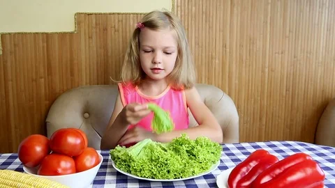 Girl eats vegetables and herbs Stock Footage 81181981