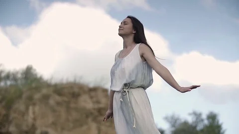 A girl on the edge of cliff enjoying life and dreaming Stock Footage