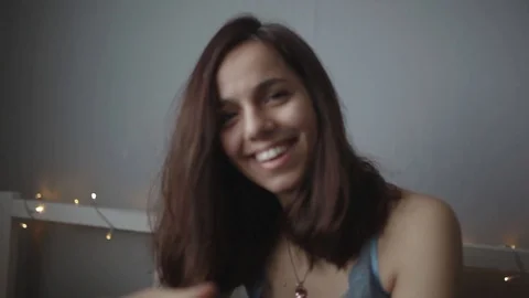 Girl is embarrassed in bed while she is being filmed Stock Footage 103150699