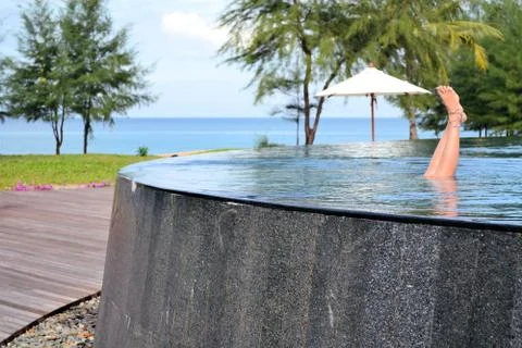 Girl in empty infinity pool Stock Photos