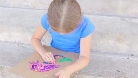 The girl is engaged in creative modeling from plasticine. The child creates a Video stock 168805586