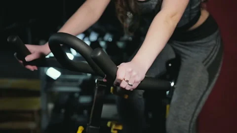 The girl is engaged in the exercise bike 스톡 동영상 86790420