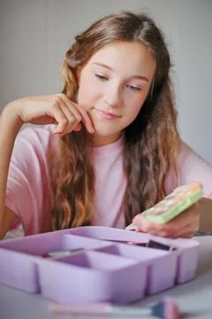 Girl enjoying creative time while exploring colorful art supplies in her co.. Stock Photos
