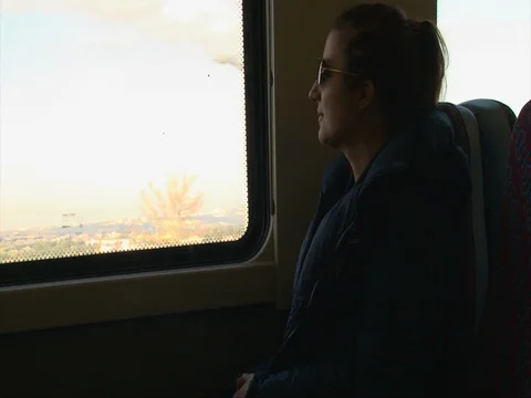 Girl enjoying looking at nature through train window, attractive visitor Stock Footage 74134853