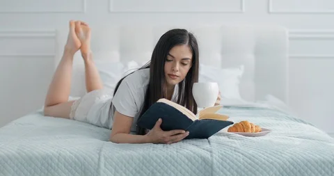 Girl Enjoying Reading While Drinking Coffee Видео 103836910