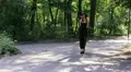 girl in an evening dress goes down the street HD Footage