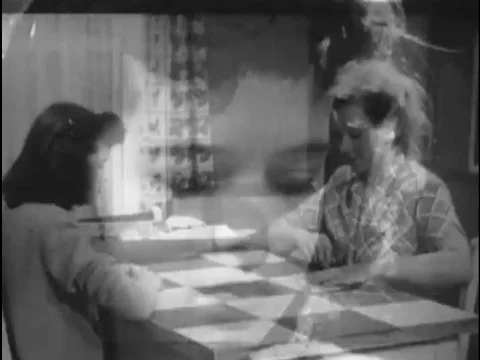A girl examines colored threads in a printed pattern in the 1950s. Stock Footage 74934425