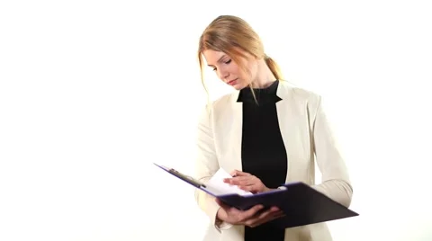 Girl examines notes on white background Stock Footage 42139334