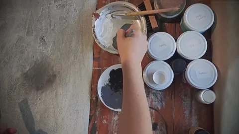 Girl exchanges gray paint with a brush Stock Footage 159890919