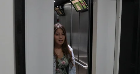 Girl exiting elevator walking inside apartment flar Stock Footage 118890830
