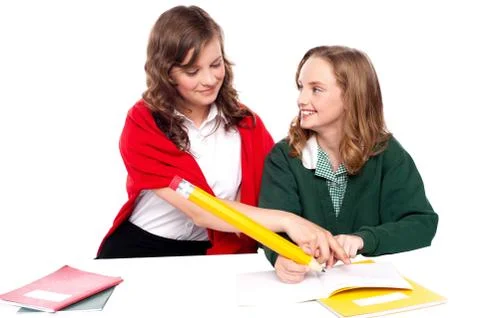 Girl explaining solution to her friend Stock Photos